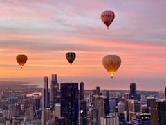 Watch the sunrise from a hot air balloon over the city