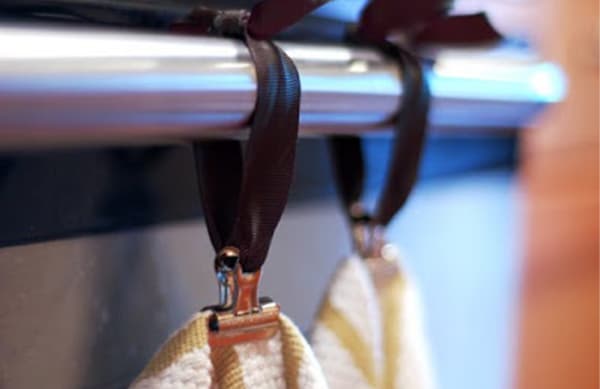 Use ribbon and binder clips to hold your kitchen towels