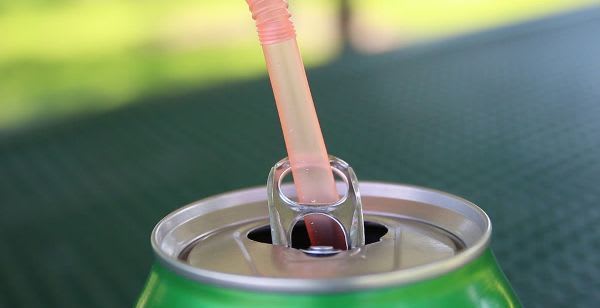 Put your straw through the tab to keep it from rising out of your drink