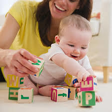 Reaches for toy with one hand