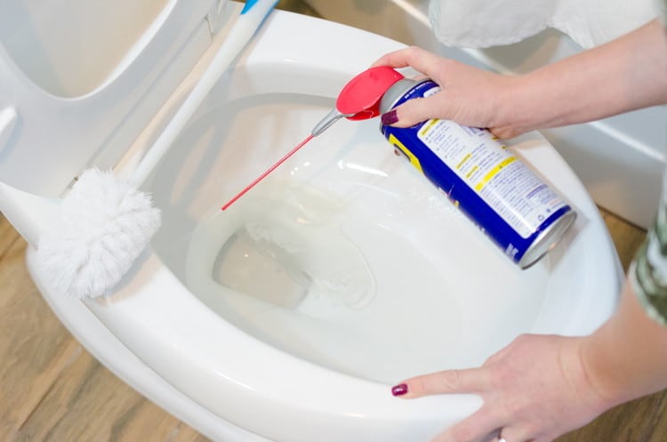 Spray your toilet bowl with WD40 for a couple of seconds and use a toilet brush to help scrub away the grime.