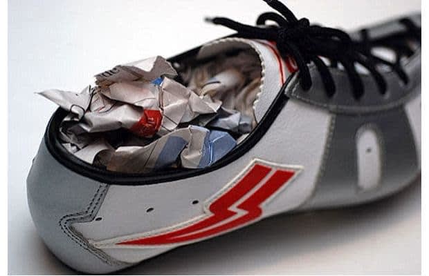 Stuff your sneakers and shoes with newspaper. They'll soak up the moisture and any smells they've managed to acquire!