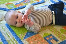 Can bring hands together and may bat at toys