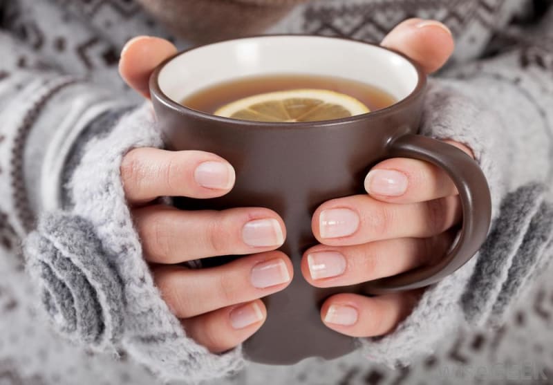 Holding a cup of steaming mug on a cold day