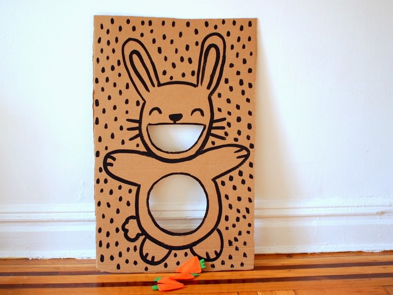 Easter-themed bean bag toss game with paper plates and bean bags